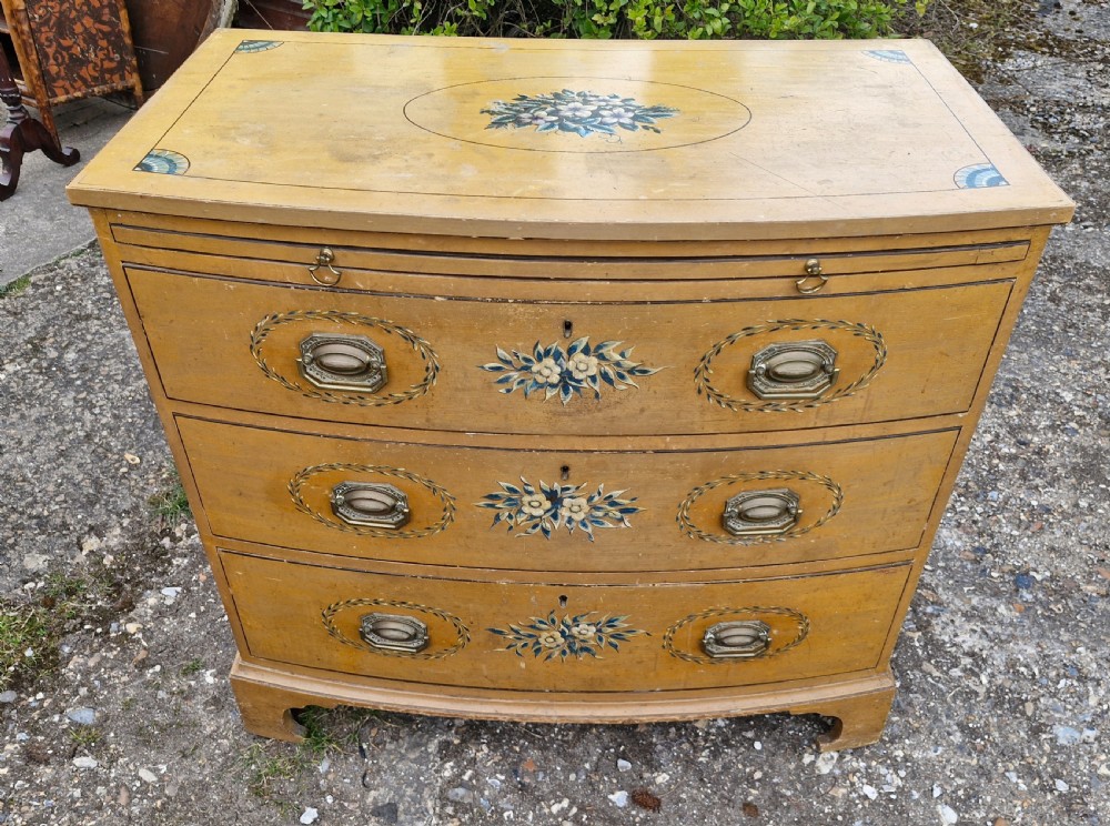 Pretty original painted bow front chest with brushing slide.