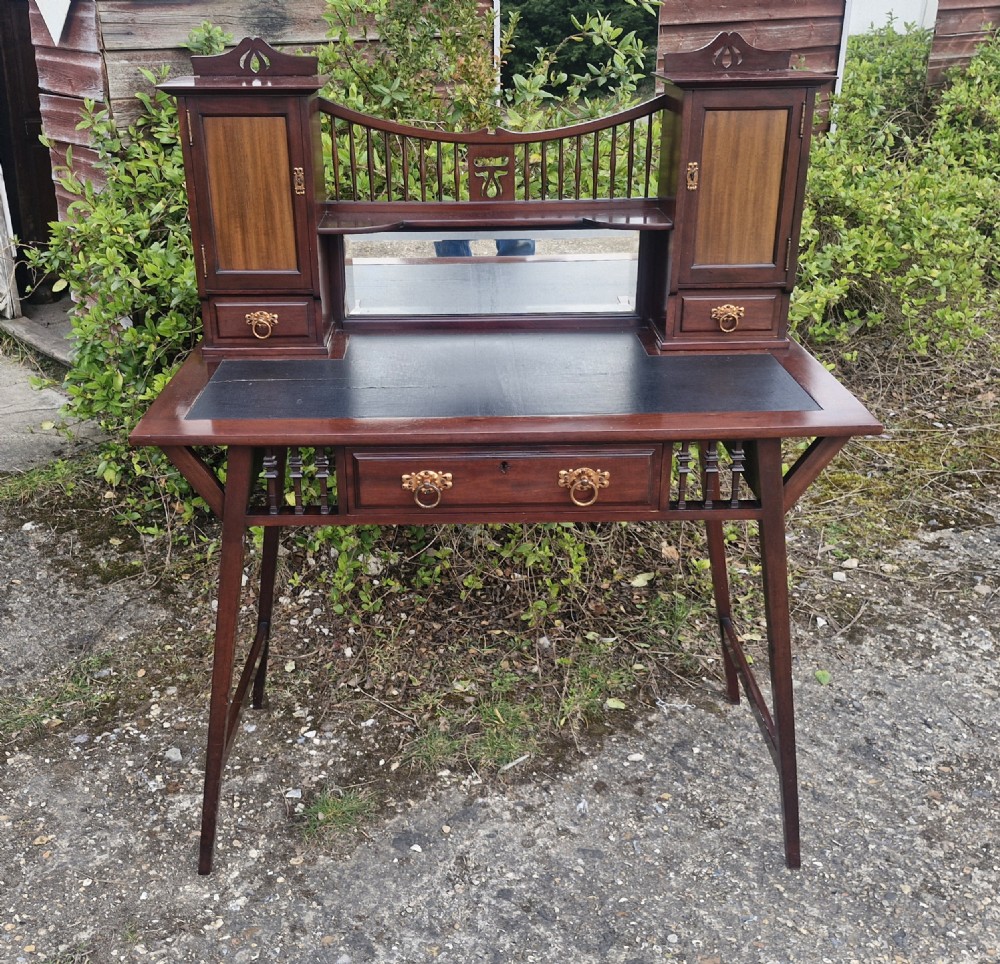 Mahogany writing table by Shapland & Petter. 