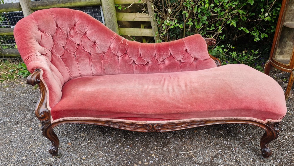 Mid 19th century rosewood upholstered chaise longue. 