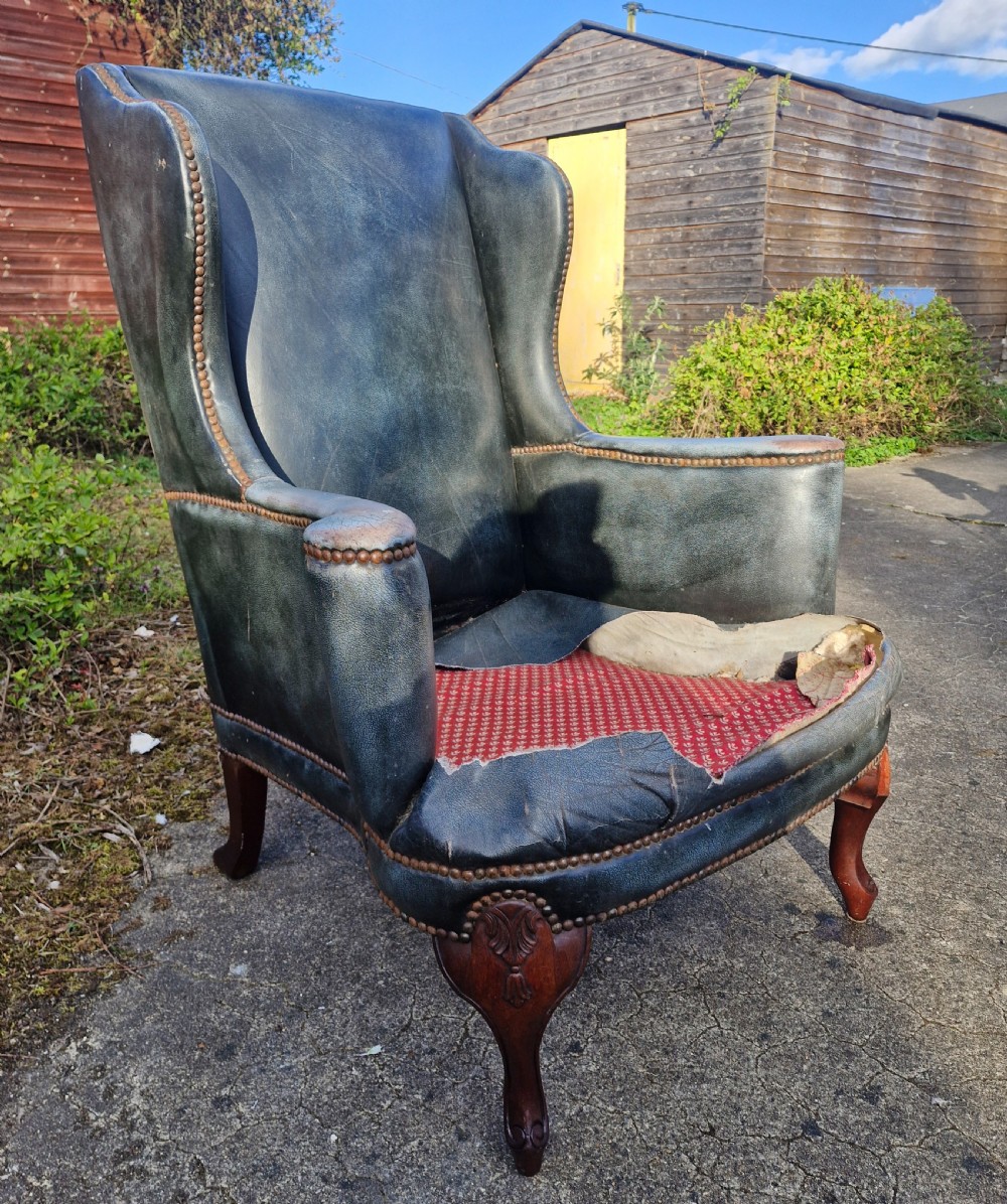 Upholstered wing back armchair.  View X