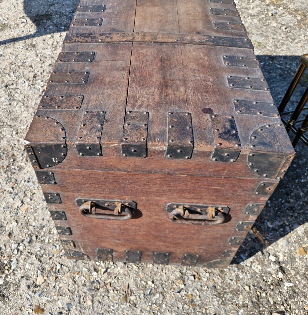 A rectangular Victorian oak chest with dark metal corner brackets, iron straps, stud detailing, and side handles. View VII