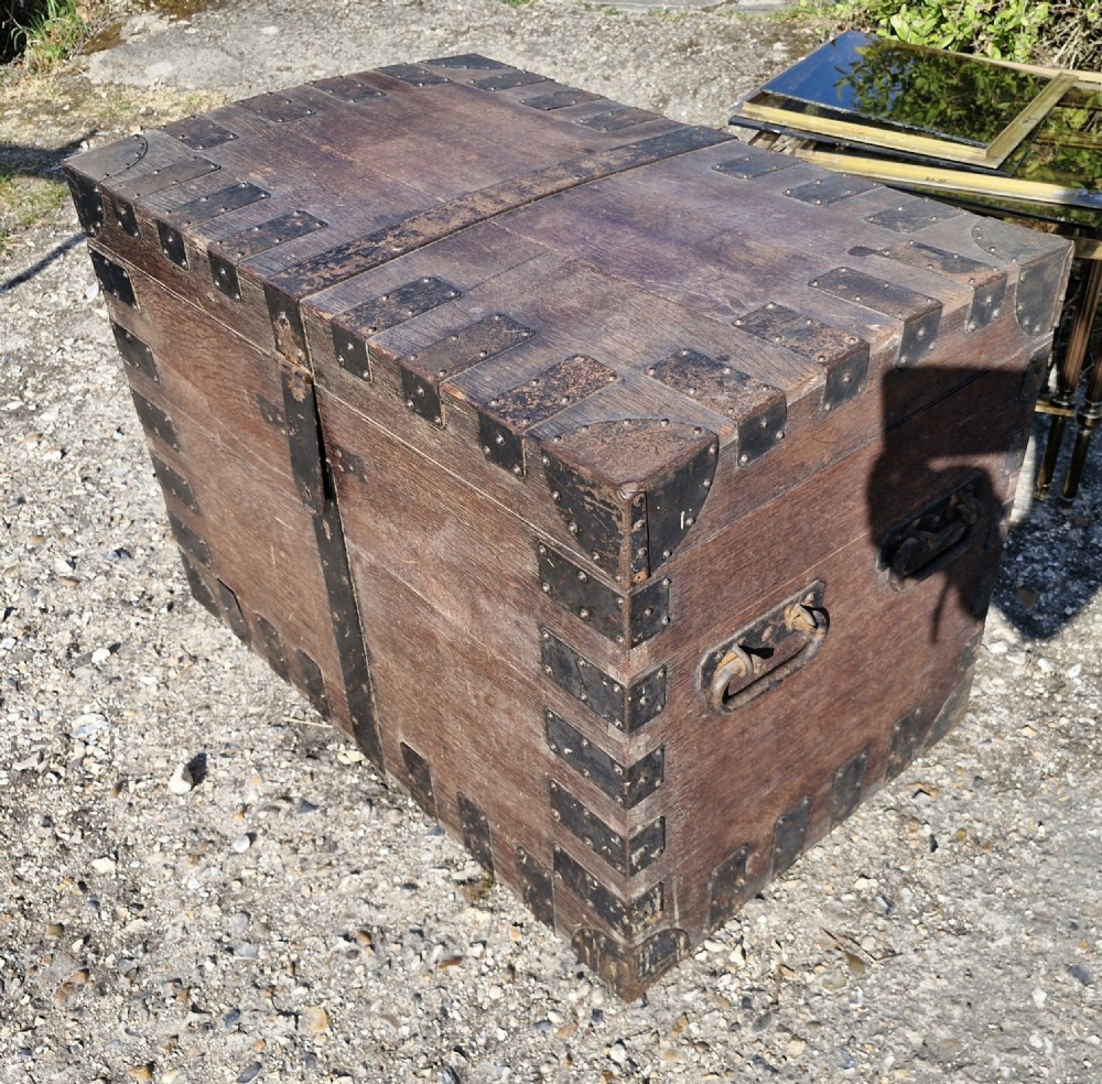 A rectangular Victorian oak chest with dark metal corner brackets, iron straps, stud detailing, and side handles. View VIII