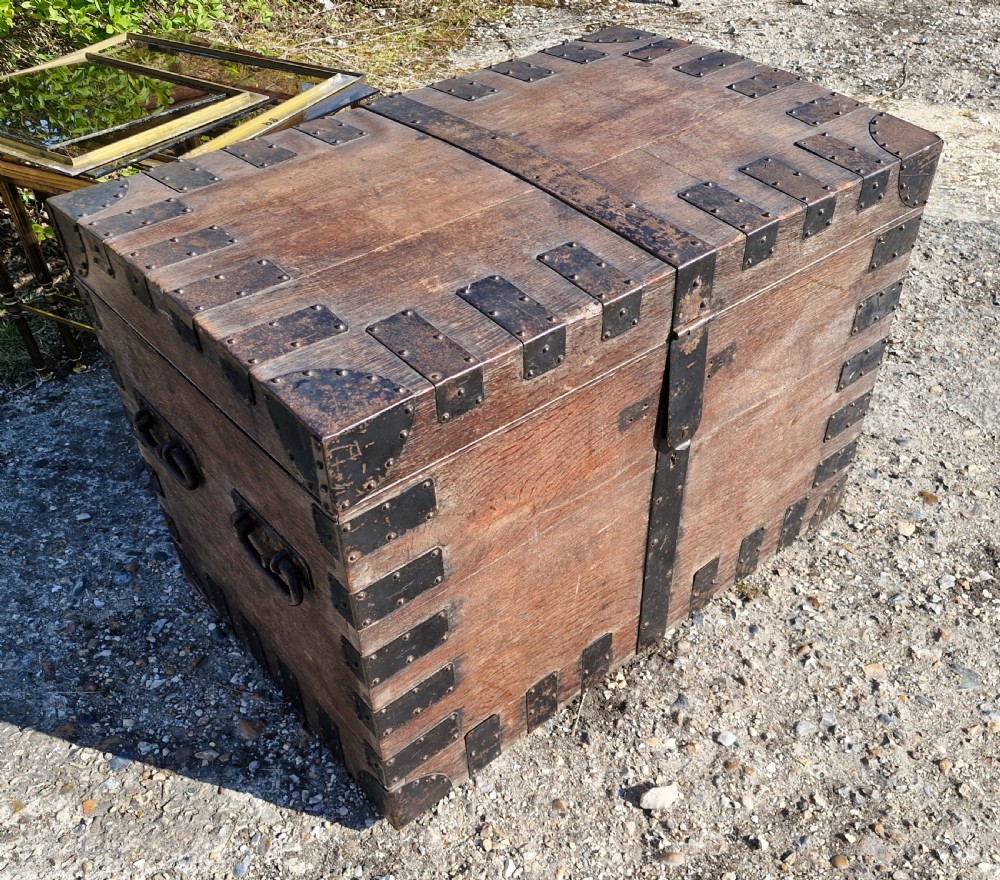 A rectangular Victorian oak chest with dark metal corner brackets, iron straps, stud detailing, and side handles. View IX