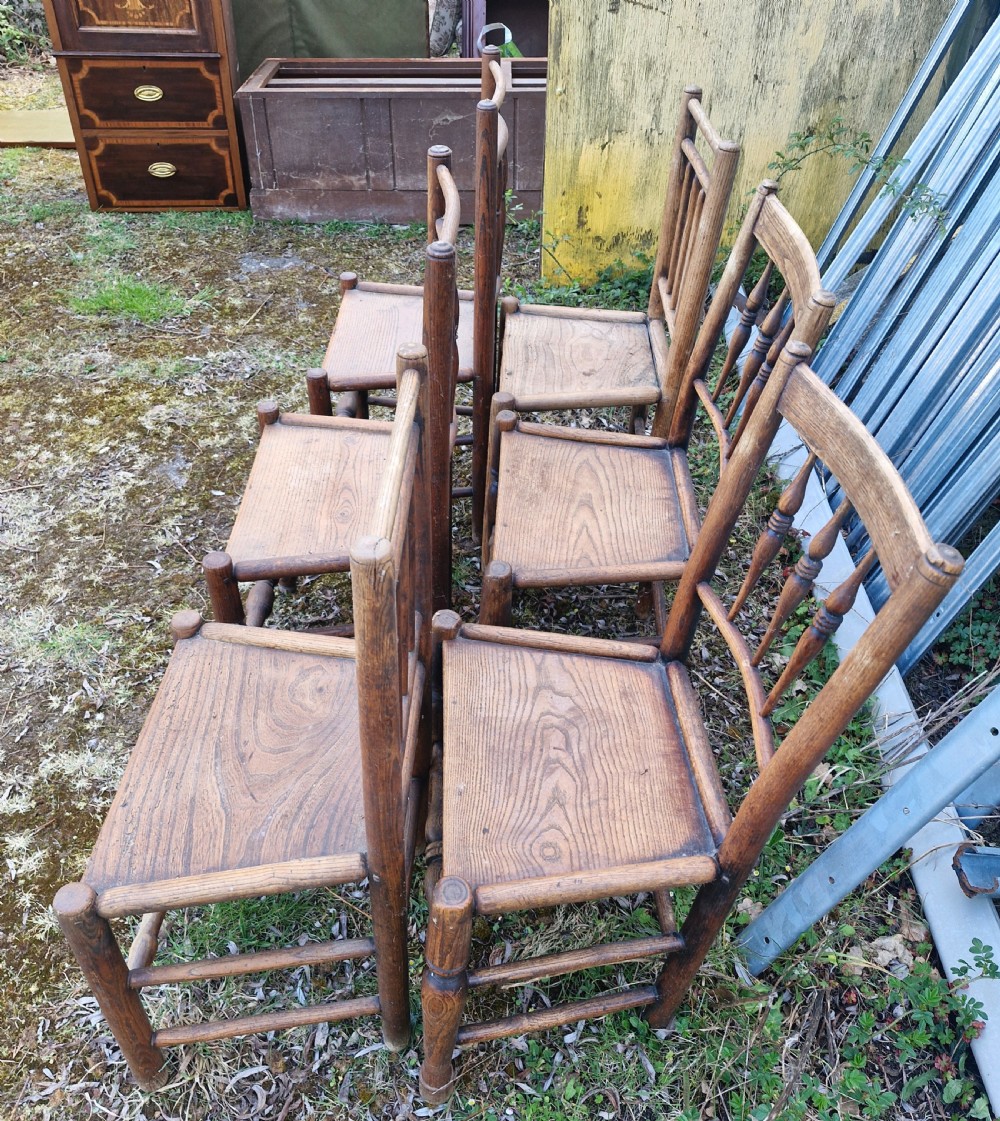 A set of six early nineteenth-century country wooden dining chairs featuring spindle backrests, solid timber seats, and turned legs with stretchers. View II