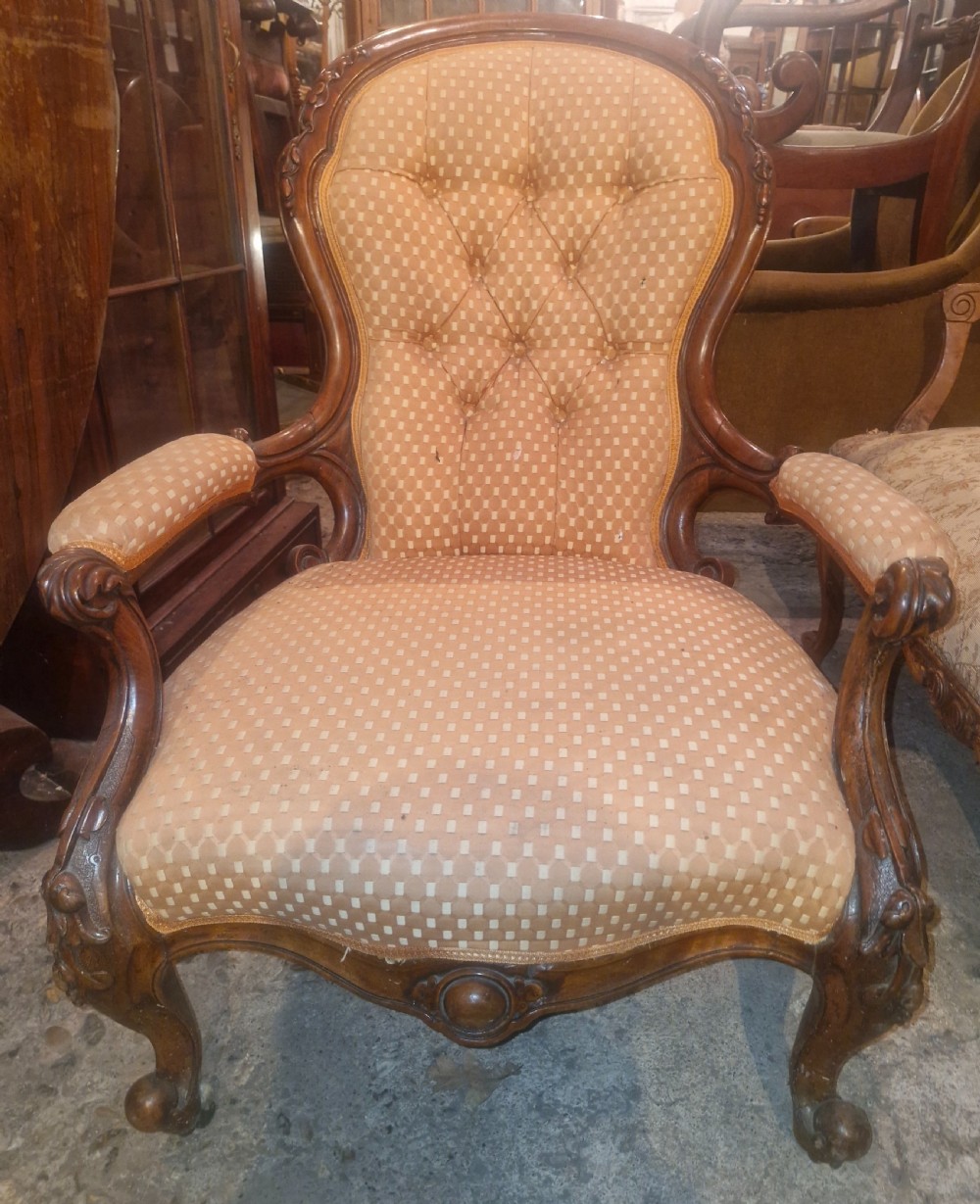 Victorian carved walnut upholstered spoon back armchair. 
