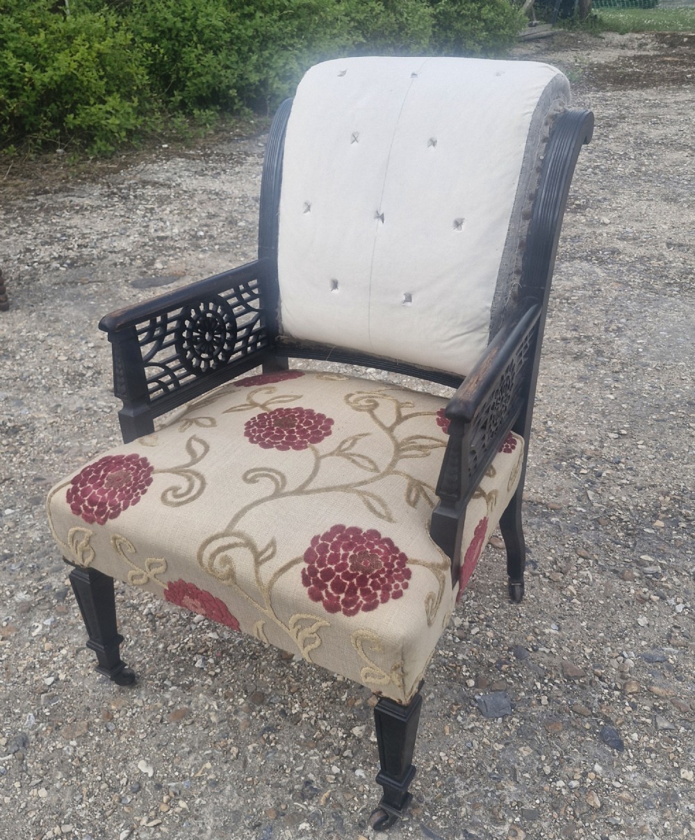 Aesthetic ebonised upholstered armchair. 
