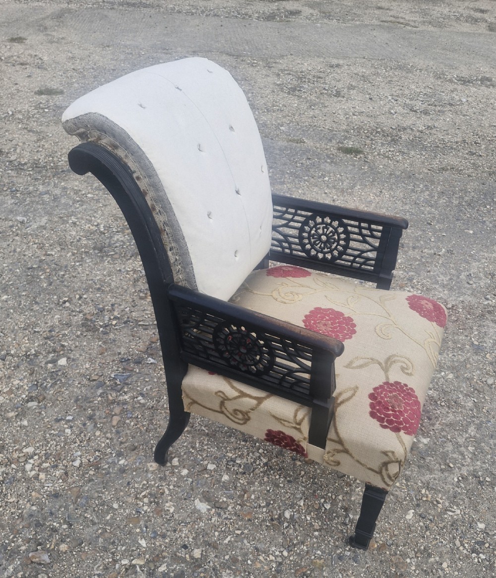 Aesthetic ebonised upholstered armchair.  View IV