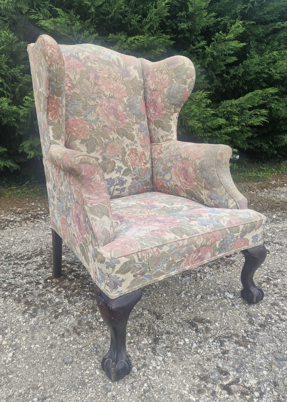 Edwardian mahogany framed wing back upholstered armchair on ball and Claw Feet.