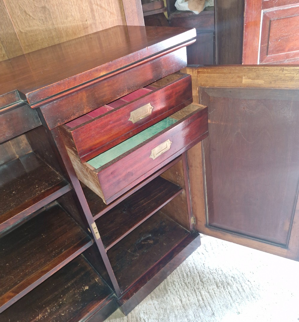 Regency mahogany inverted library bookcase cabinet fitted shelves and drawers.  View II