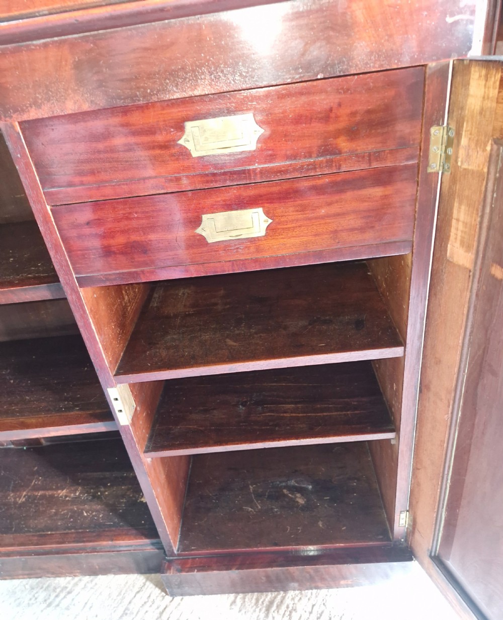 Regency mahogany inverted library bookcase cabinet fitted shelves and drawers.  View III