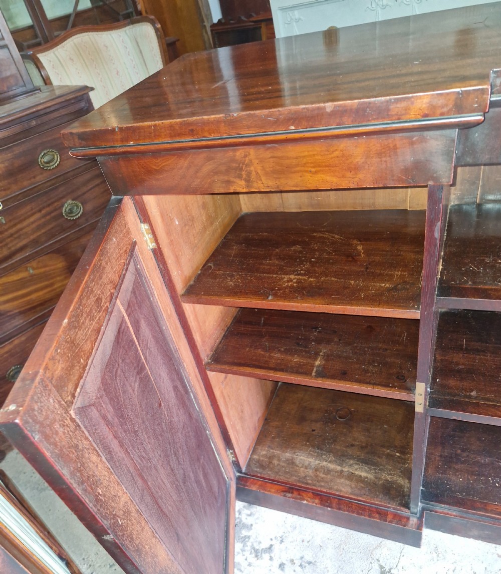 Regency mahogany inverted library bookcase cabinet fitted shelves and drawers.  View V