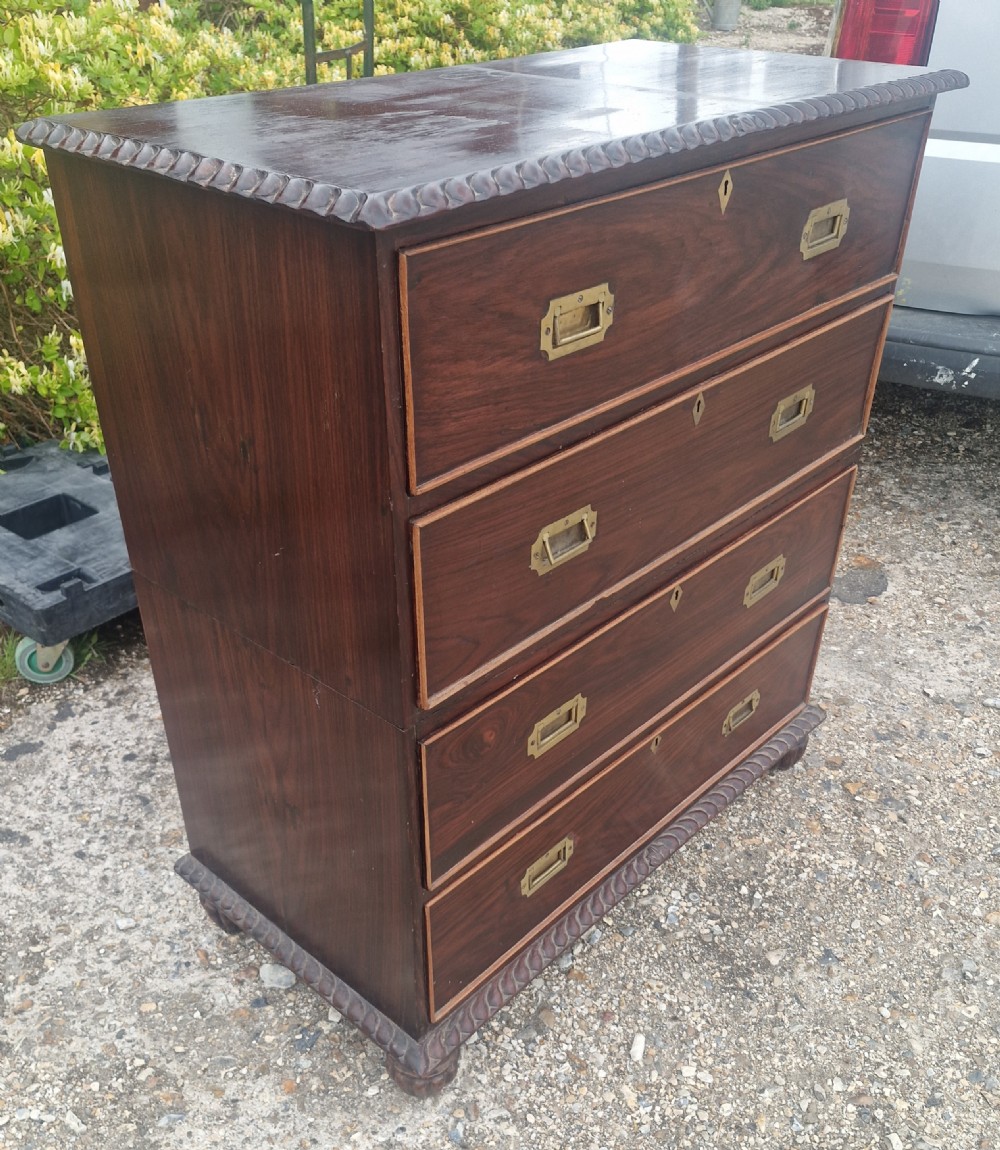 A four-drawer dark rosewood Anglo-Indian campaign secretaire chest featuring recessed brass handles, diamond escutcheons, and carved gadrooned borders. View XI