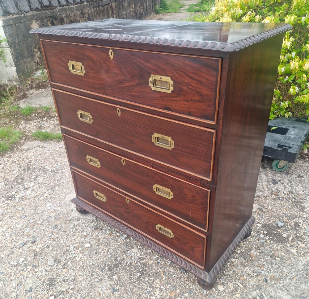A four-drawer dark rosewood Anglo-Indian campaign secretaire chest featuring recessed brass handles, diamond escutcheons, and carved gadrooned borders. View XIV