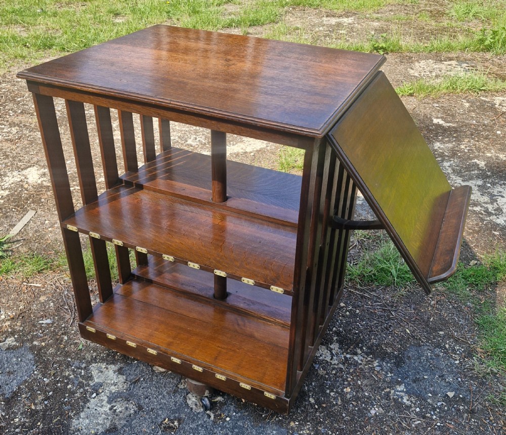 Edwardian oak revolving bookcase with adjustable reading slope. 