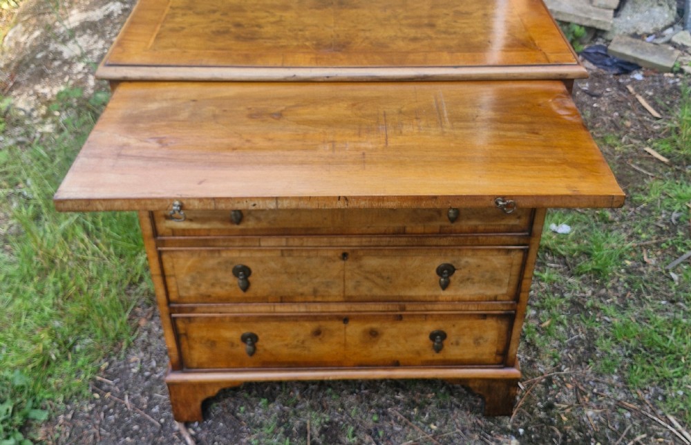 Early 20th century walnut chest of drawers with brushing slide.  View II