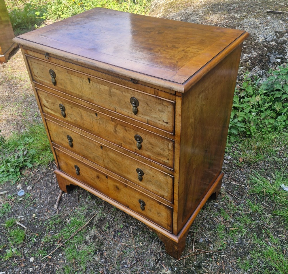 Early 20th century walnut chest of drawers with brushing slide.  View III
