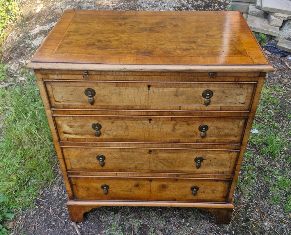 Early 20th century walnut chest of drawers with brushing slide.  View VII
