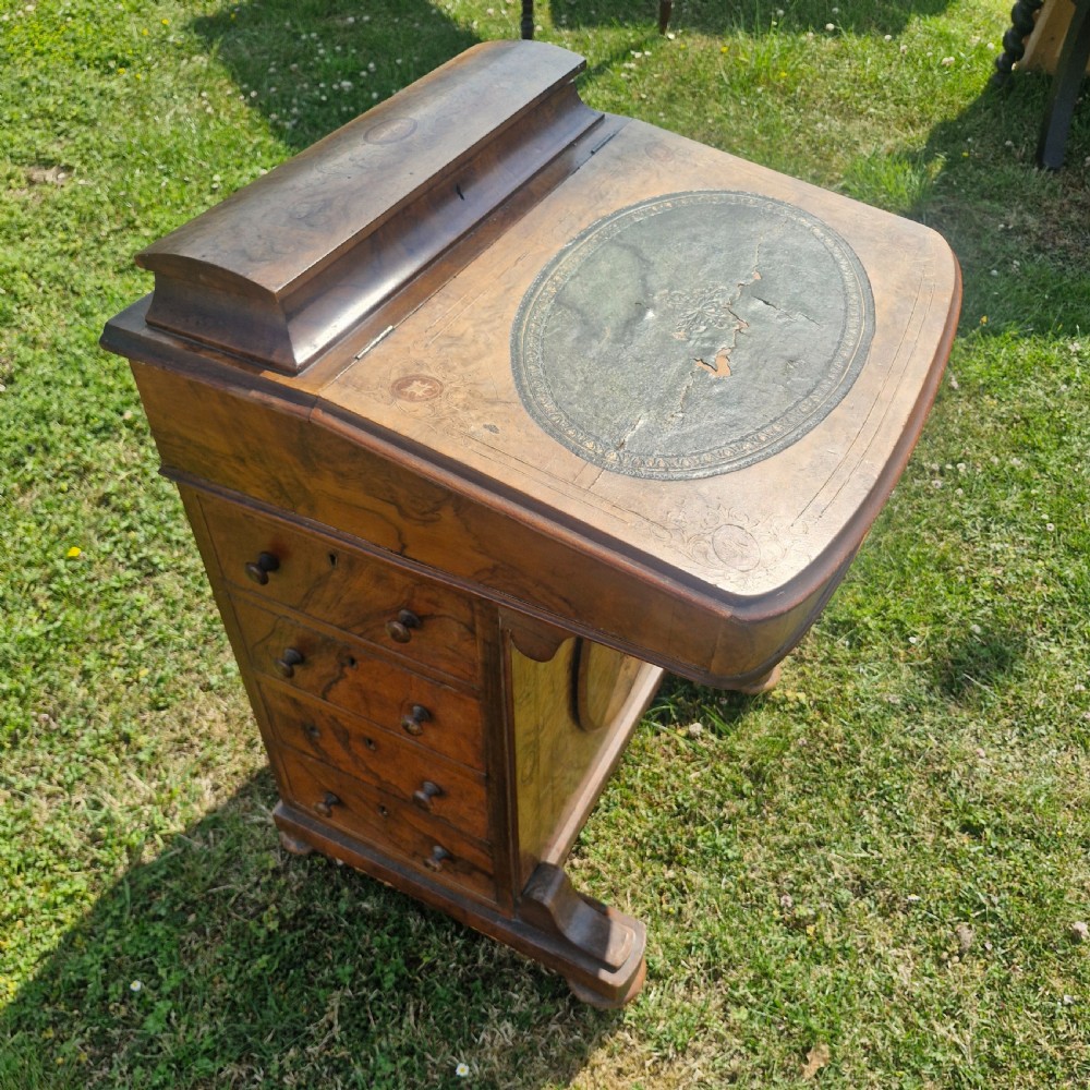 A Victorian walnut Davenport desk featuring a green leather writing slope, floral marquetry inlay, a raised top stationery box, and four side drawers. View V