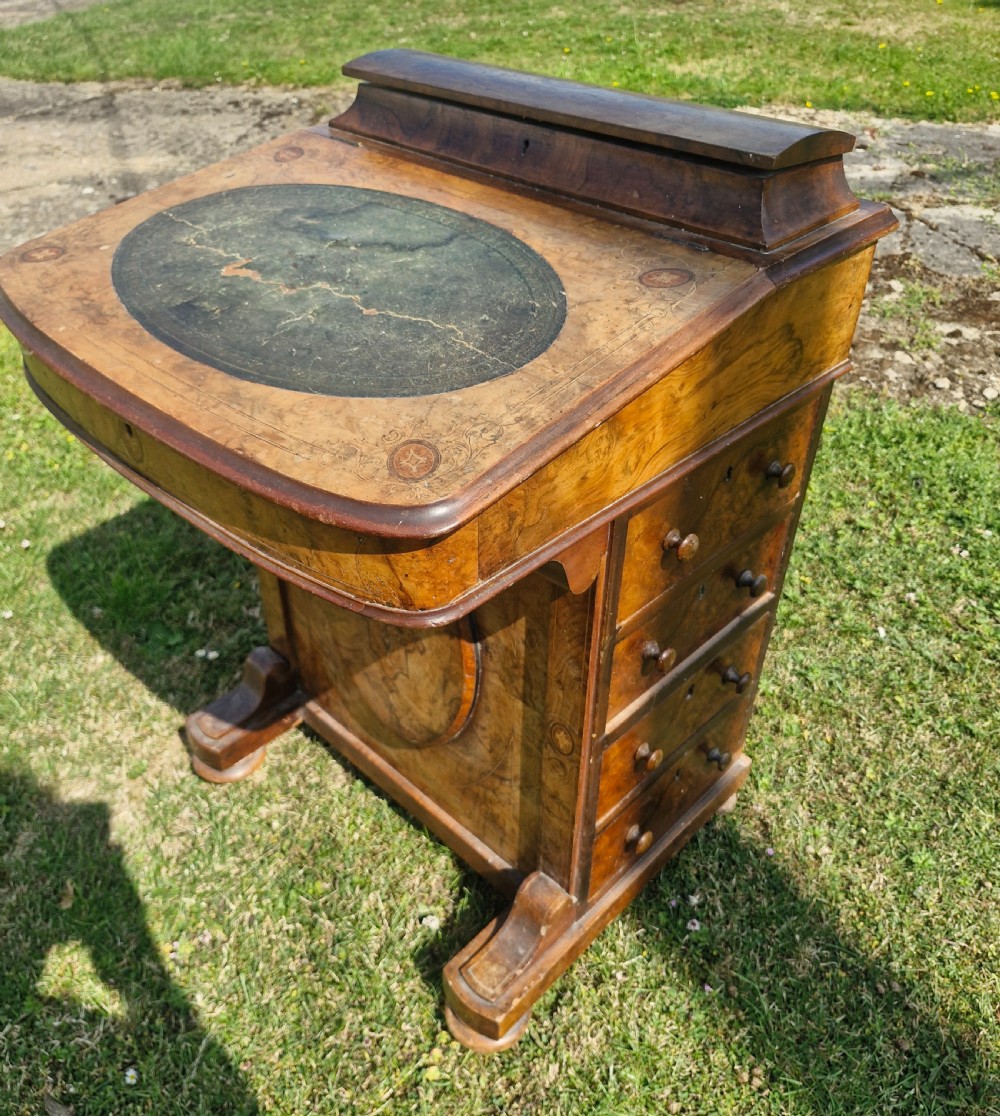 A Victorian walnut Davenport desk featuring a green leather writing slope, floral marquetry inlay, a raised top stationery box, and four side drawers. View VII