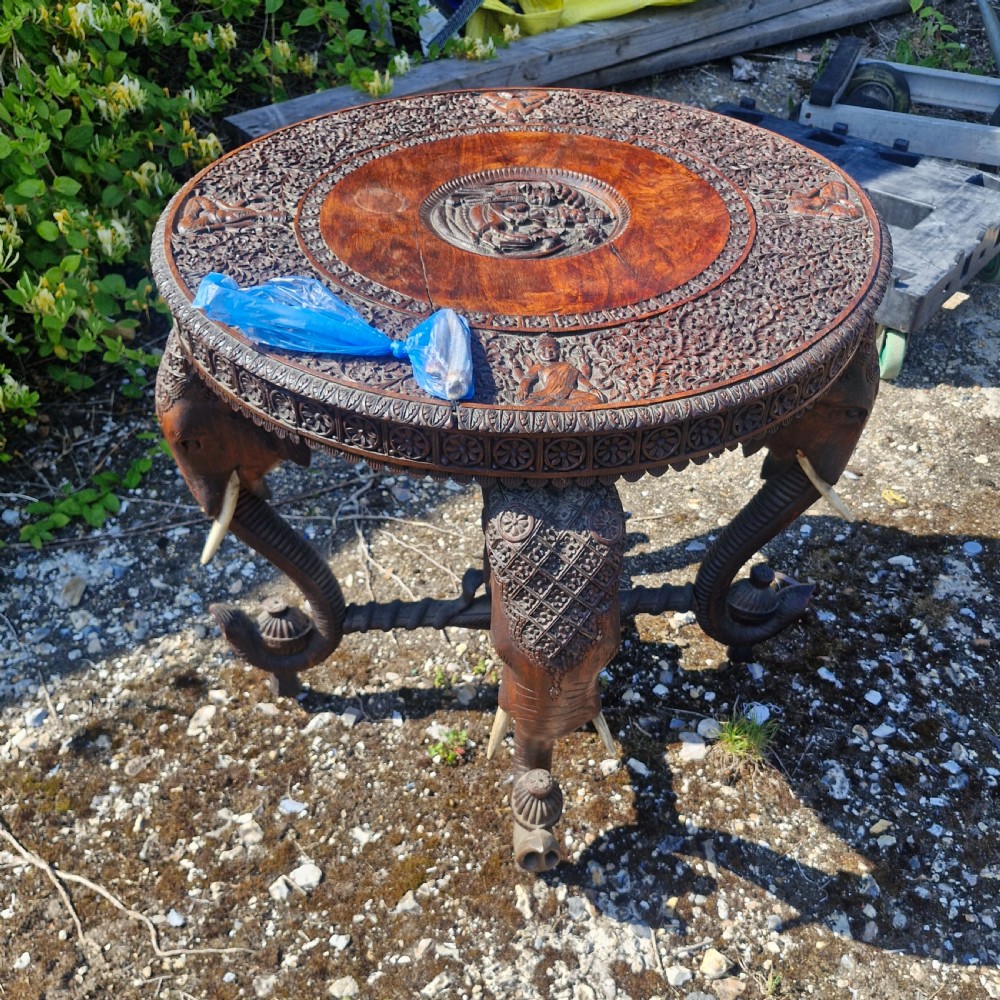 Large Carved Anglo Indian elephant table with wooden tusks.