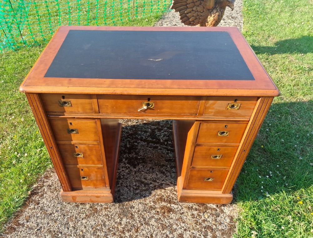 Small kneehole pedestal desk with Wellington type locking drawers.