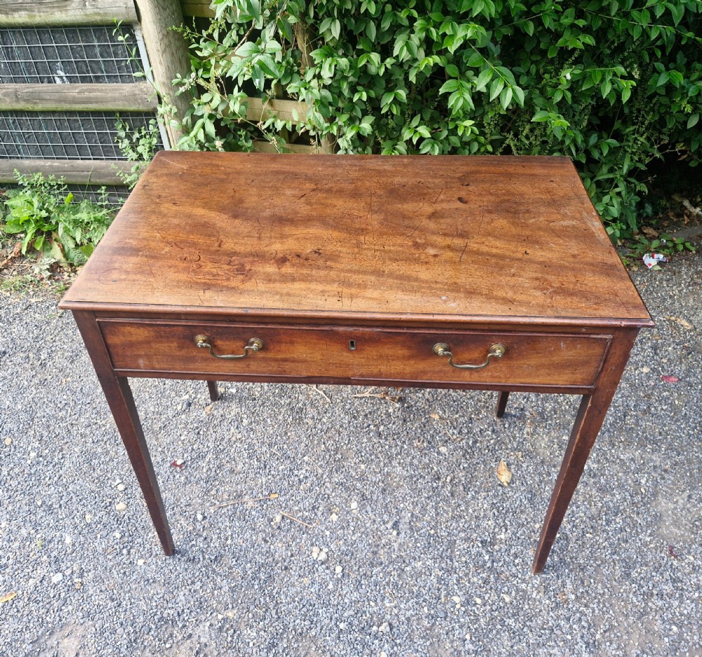 A late Georgian mahogany side table featuring a single long drawer with two brass swan-neck handles and four square tapered legs. View VII