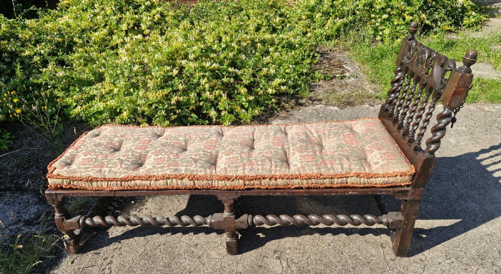 Early 18th century oak and walnut caned day bed.