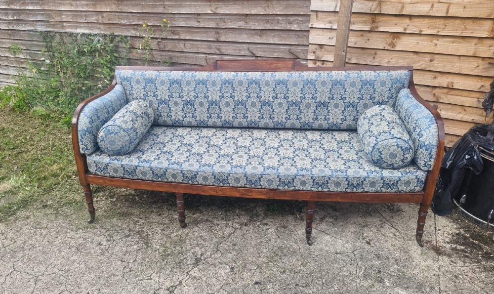 Regency upholstered and cane seat sofa.