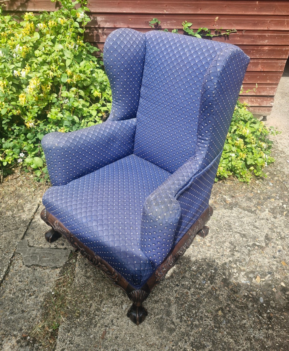 A blue pattern upholstered wingback armchair with a carved mahogany frame featuring shell motifs and claw and ball feet. View II