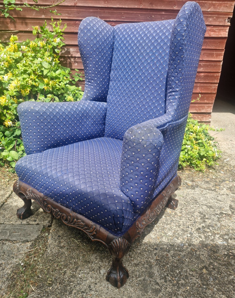 A blue pattern upholstered wingback armchair with a carved mahogany frame featuring shell motifs and claw and ball feet. View III