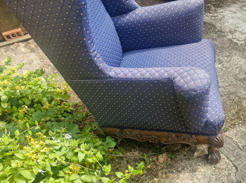 A blue pattern upholstered wingback armchair with a carved mahogany frame featuring shell motifs and claw and ball feet. View IV