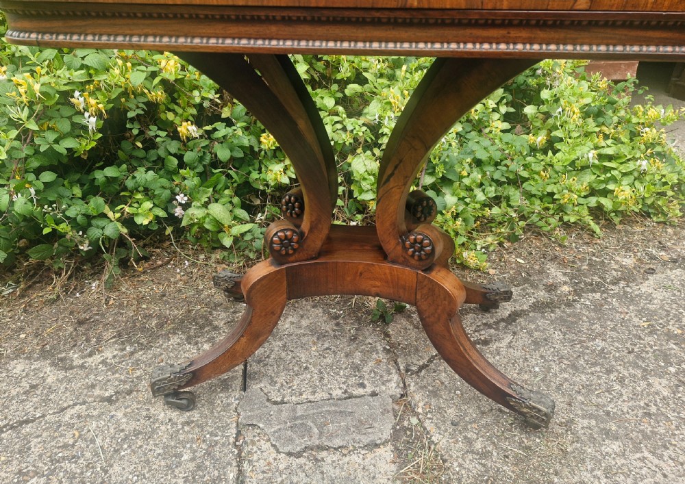 Regency rosewood swivel top games table in the manner of William Trotter. View II