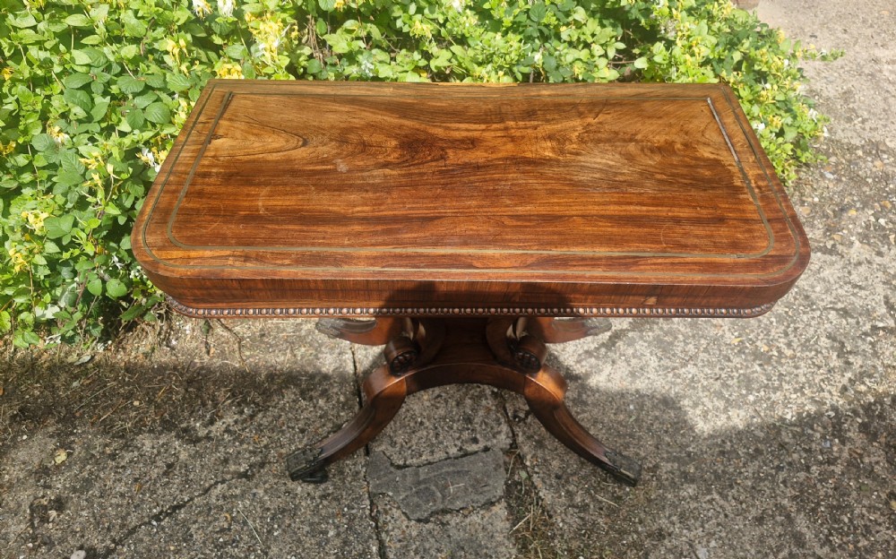 Regency rosewood swivel top games table in the manner of William Trotter. View IV