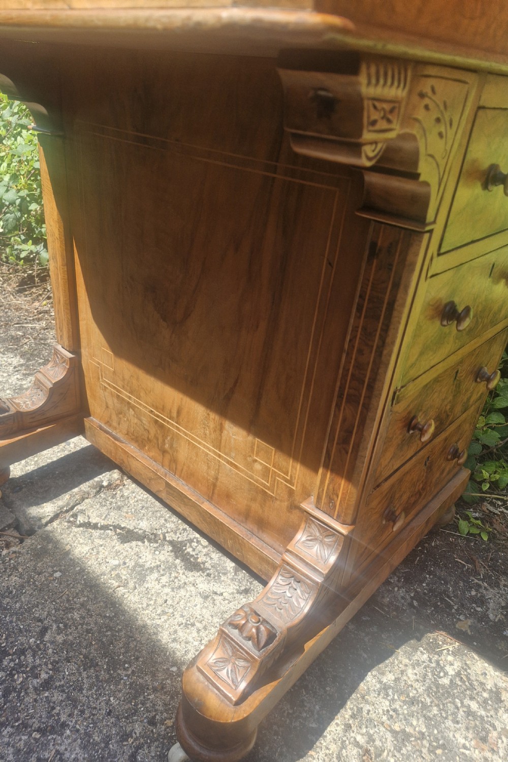 A Victorian burr walnut Davenport desk with a sloped red leather writing surface, inlaid top cresting, and side drawers. View III