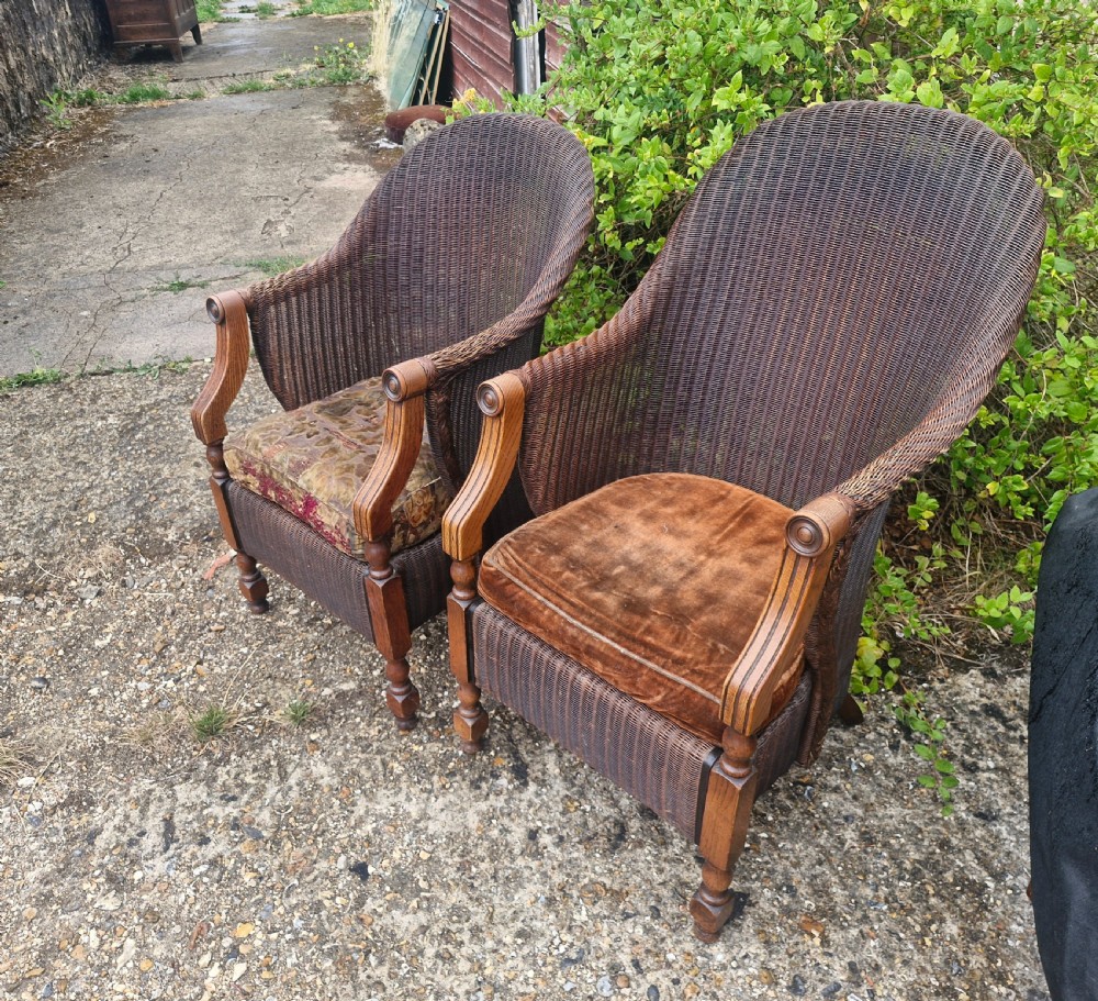 Rare pair of Oak framed Lloyd Loom Ladys and Gents armchairs.