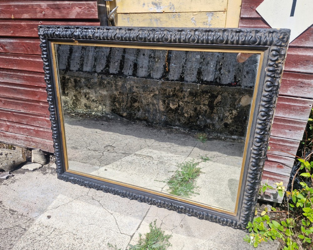 Impressive black and gilt Victorian wall mirror.  View II