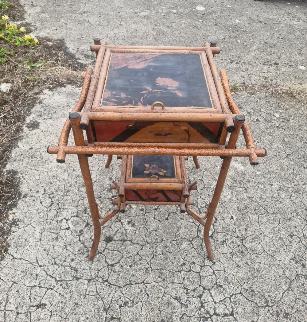 A two-tier Victorian tiger bamboo table with dark lacquered panels featuring floral decorations. View II