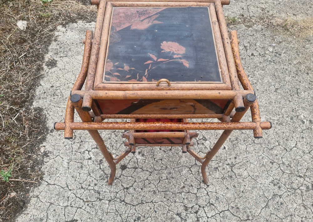 A two-tier Victorian tiger bamboo table with dark lacquered panels featuring floral decorations. View VII