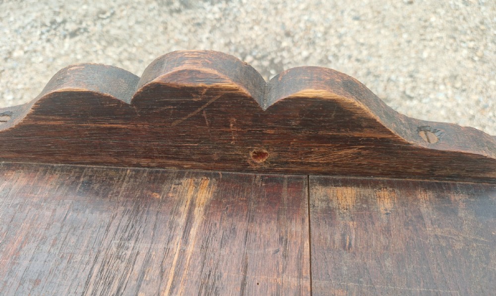 Late Victorian dark oak monks hall seat featuring intricate carved foliate panels, turned arm supports, and an integrated storage chest base. View VIII