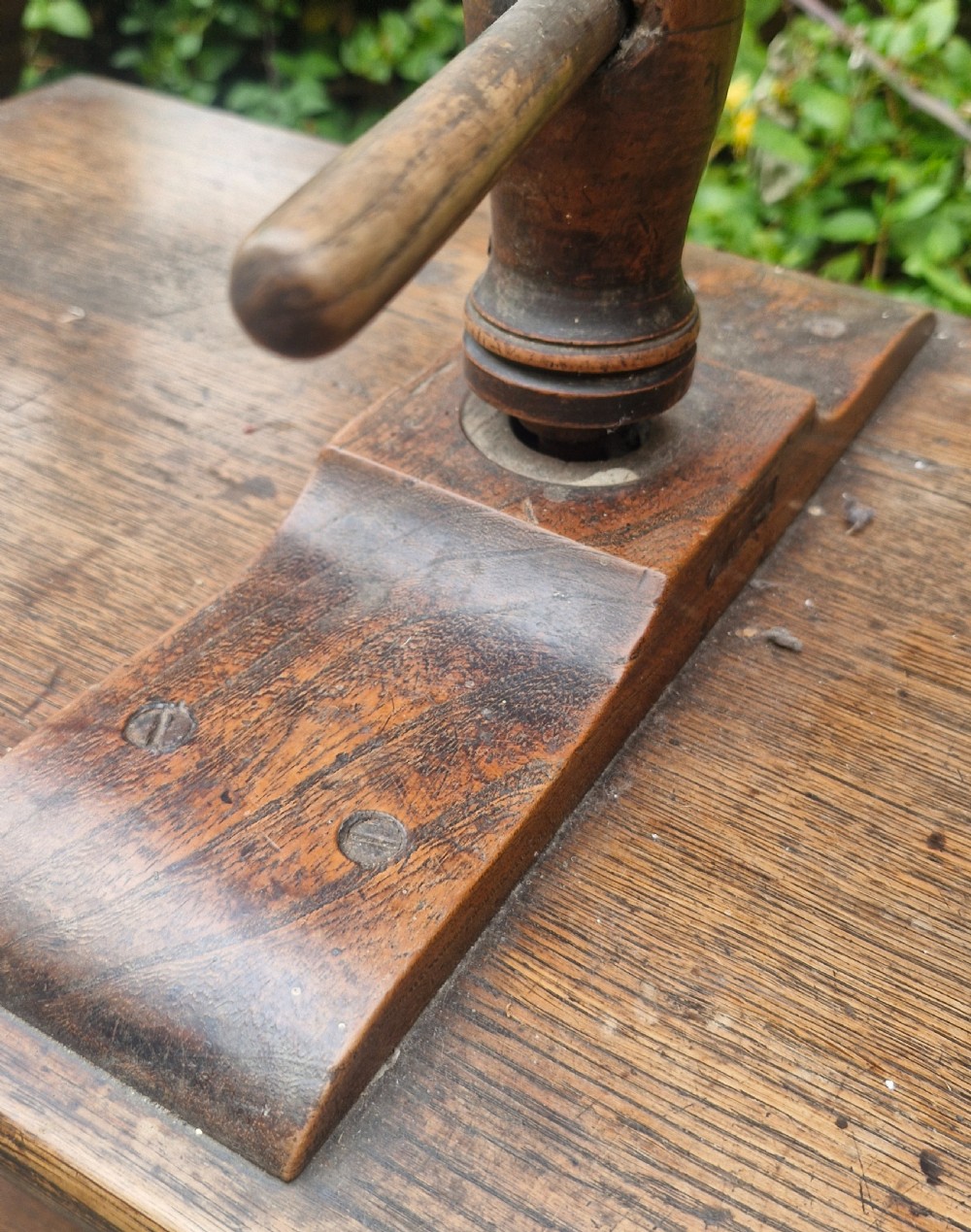 An antique Georgian dark oak tabletop book press featuring a central wooden threaded screw stem, an upper frame, and a base drawer with brass knobs. View II