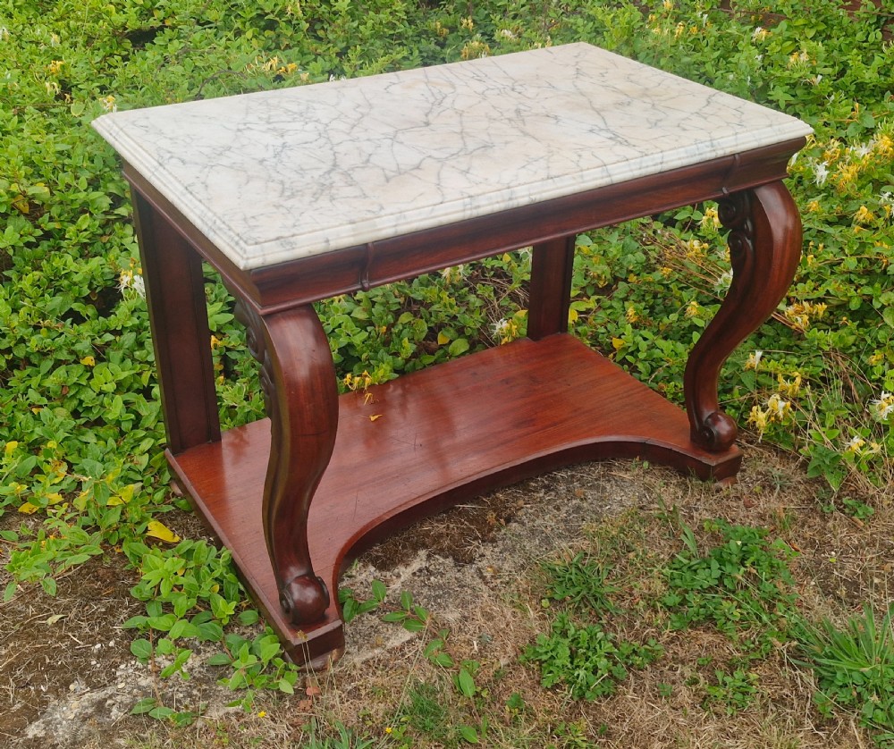 Regency mahogany marble top hall table with all round bevel edge.