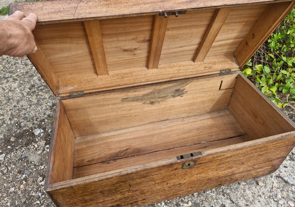 An early 20th century rectangular teak trunk featuring a hinged lid, a central metal lockplate, and side carrying handles. View III