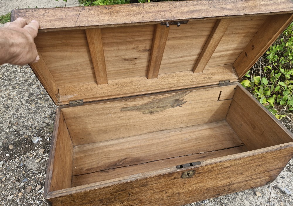 An early 20th century rectangular teak trunk featuring a hinged lid, a central metal lockplate, and side carrying handles. View V