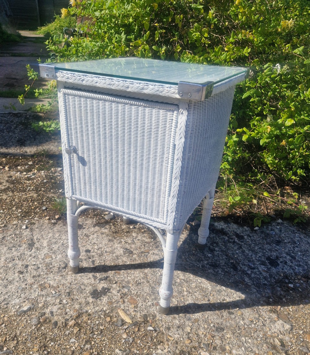 Large Lloyd Loom bathroom cabinet with plate glass top.