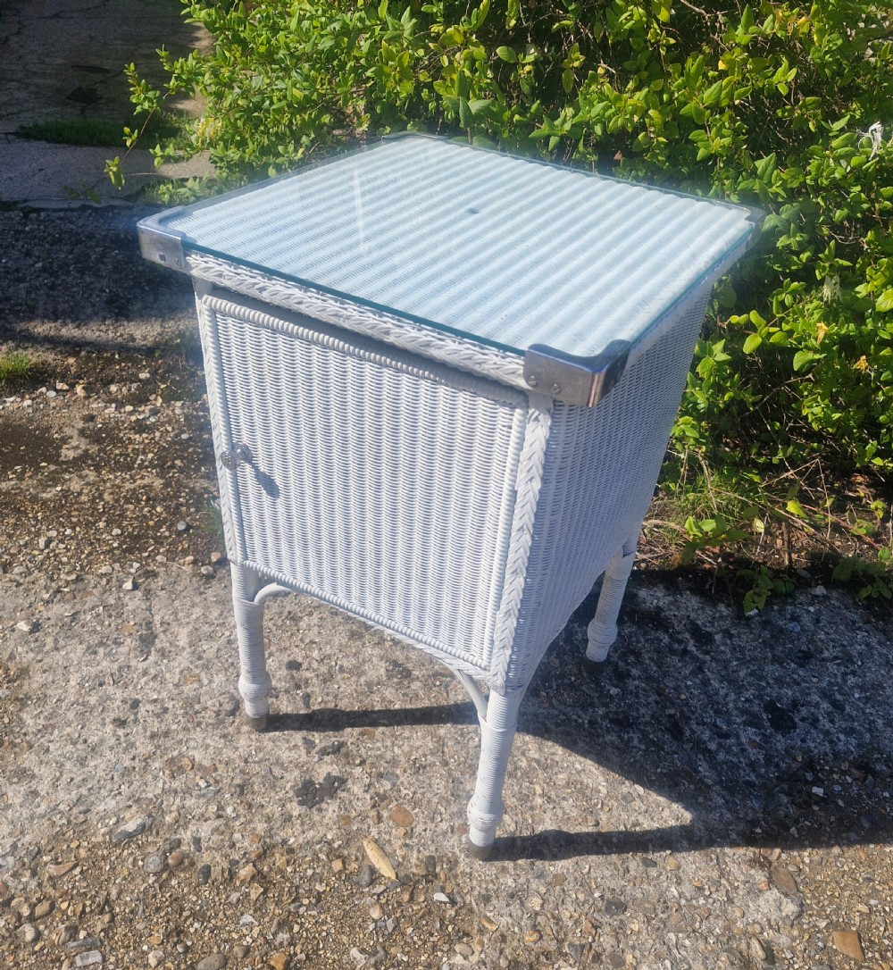 Large Lloyd Loom bathroom cabinet with plate glass top. View VI