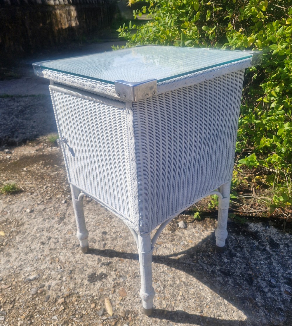 Large Lloyd Loom bathroom cabinet with plate glass top. View VII