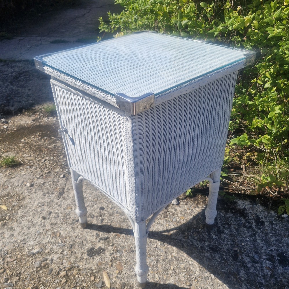 Large Lloyd Loom bathroom cabinet with plate glass top. View VIII