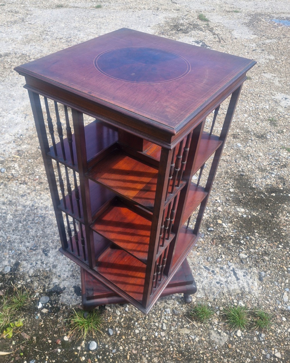 Edwardian inlaid mahogany revolving bookcase with makers stamp. View IV