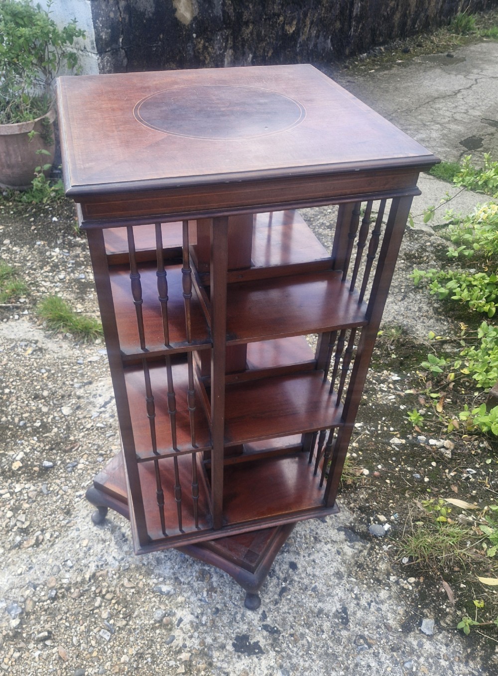 Edwardian inlaid mahogany revolving bookcase with makers stamp. View V