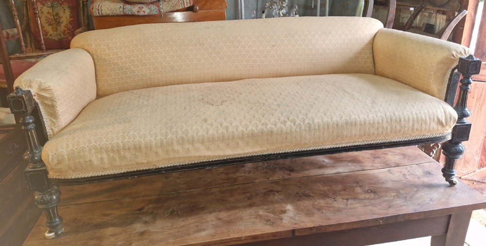 Late Victorian ebonised framed upholstered sofa. View II